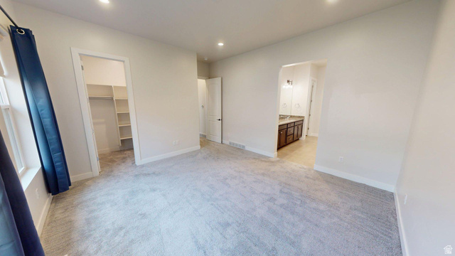 5502 North Valley View Road Lehi, UT 84048 - Photo 12 of 33 Carpeted interior space featuring recessed lighting and a window with dark blue curtains