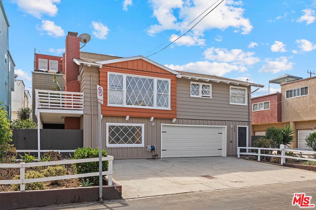 a front view of a house with garage