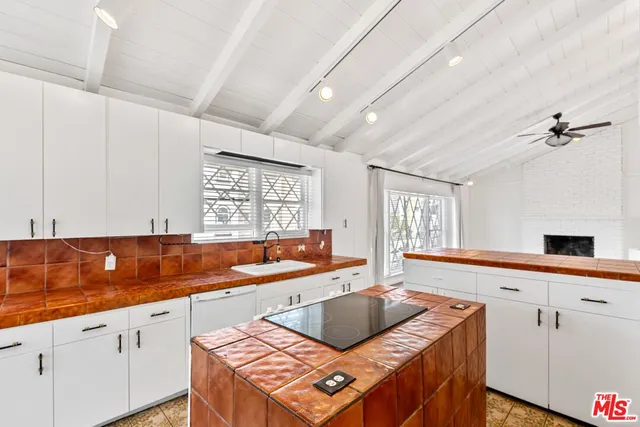 a kitchen with a sink and a large window