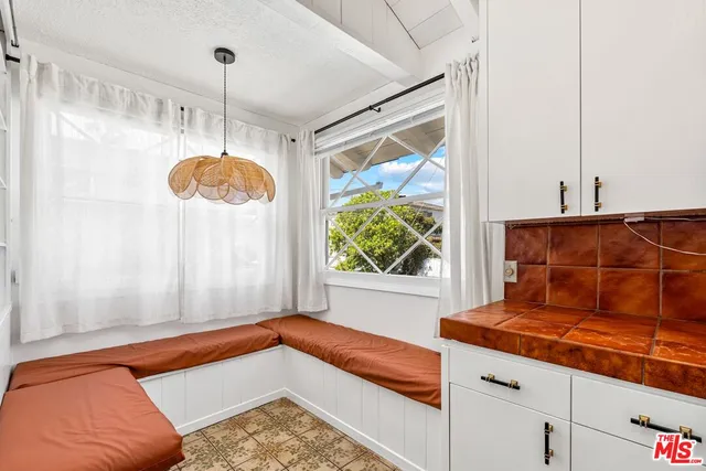 a room with pool table and windows
