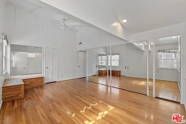 a view of empty room with wooden floor