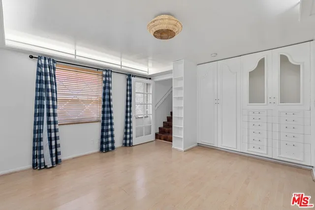 a view of an empty room with closet