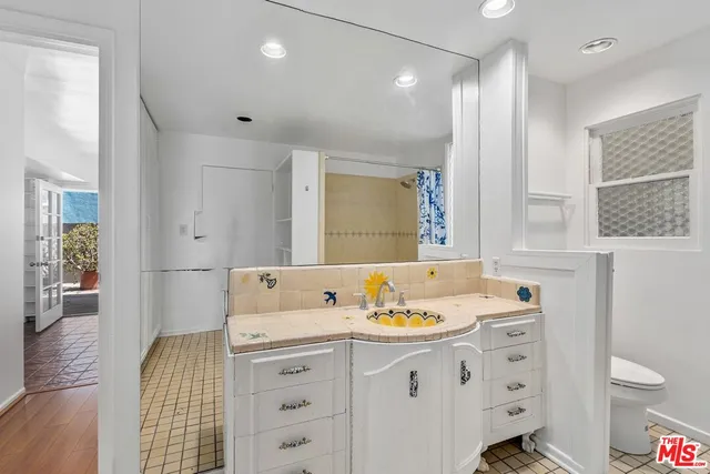 a bathroom with a sink double vanity and a shower