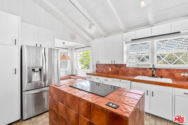 a kitchen that has a sink a refrigerator and a sink