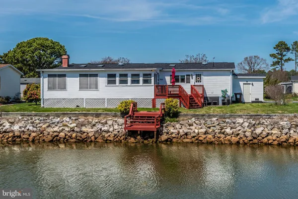 a view of a lake with a house and outdoor space