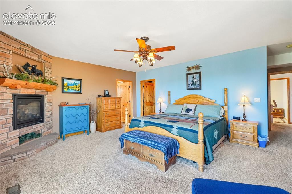 858 Oak Ridge Road Manitou Springs, CO 80829 - Photo 27 of 50 Primary bedroom on lower level with a private walk out deck, a gas fireplace, a walk in closet and an en suite 5 piece bathroom