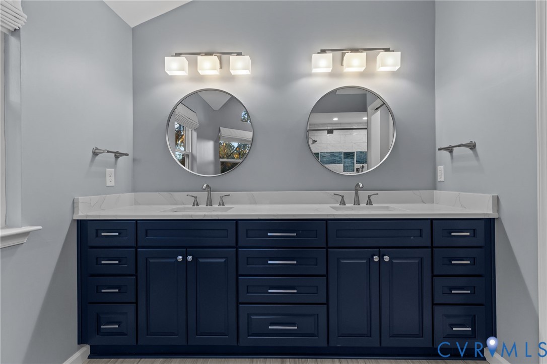 3973 West Stratford Road Virginia Beach, VA 23455 - Photo 25 of 45 a bathroom with a double vanity sink and a mirror