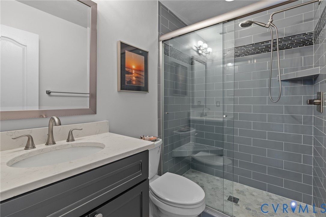 3973 West Stratford Road Virginia Beach, VA 23455 - Photo 33 of 45 a bathroom with a sink a toilet and shower