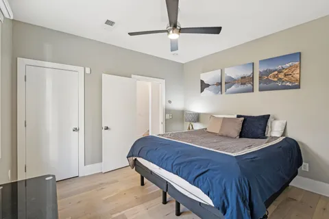 a bedroom with a bed and a ceiling fan