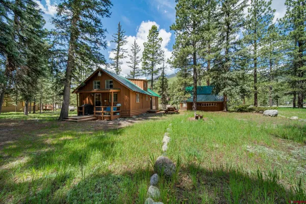 a view of house with backyard