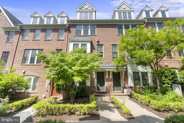 a front view of a residential houses with yard