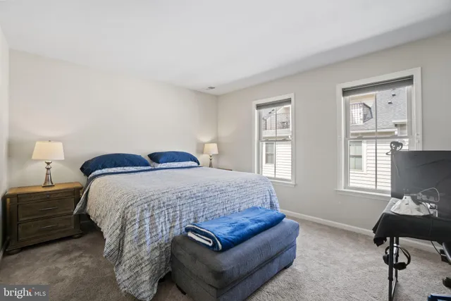a bedroom with a bed window and chair