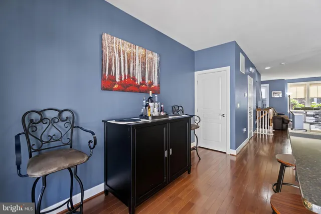 a kitchen with sink refrigerator dining table and chairs