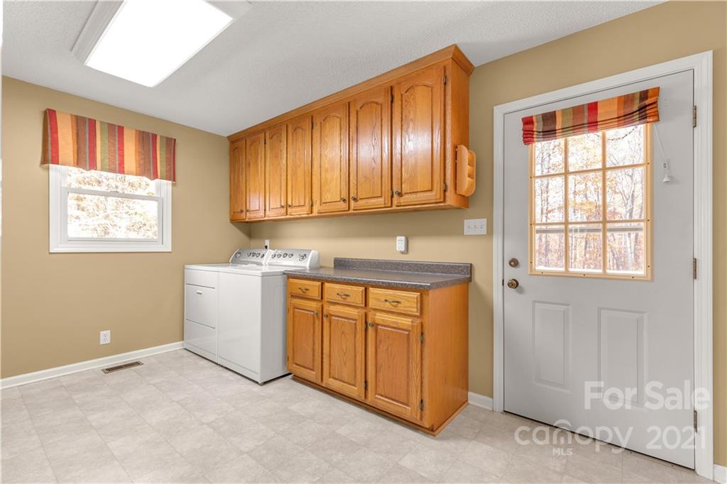 1836 Pressley Road Chester, SC 29706 - Photo 22 of 40 a view of a kitchen with wooden cabinets and a window
