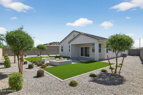 a front view of a house with garden and patio