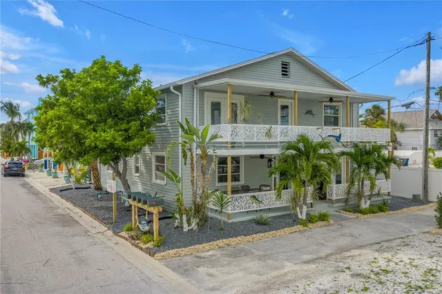 an aerial view of a house with a yard and potted plants
