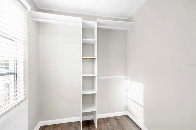 a kitchen with a refrigerator stove and white cabinets