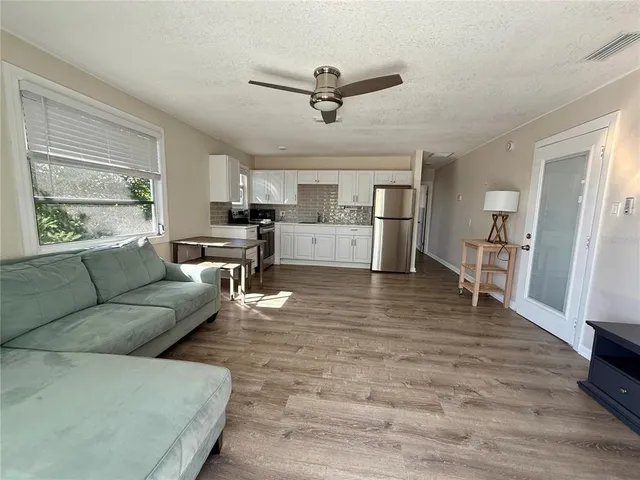 a view of a porch with wooden floor and fence
