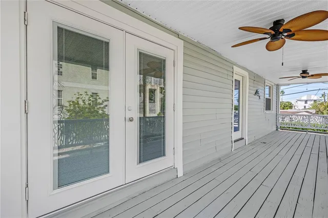 a view of a livingroom with wooden floor and a ceiling fan