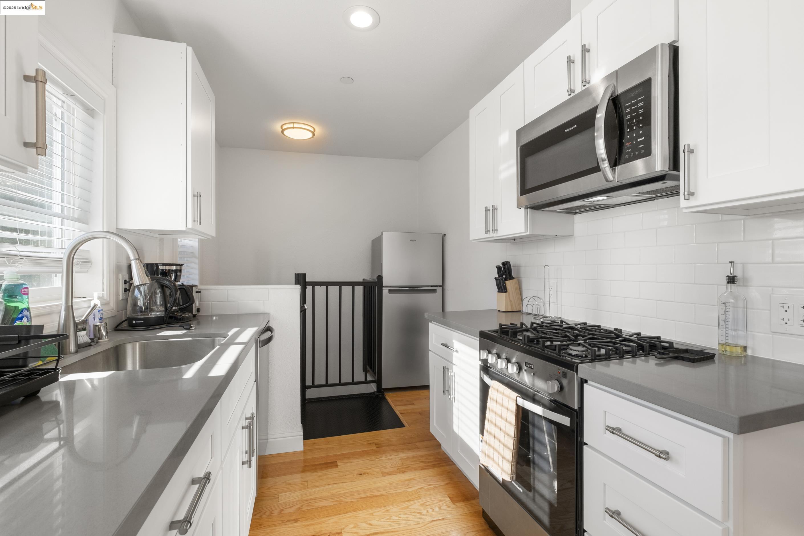 1628 Tyler Street Berkeley, CA 94703 - Photo 13 of 38 a kitchen with stainless steel appliances granite countertop a stove a sink and a microwave