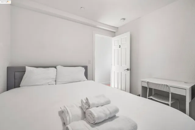 a bedroom with a bed and a desk