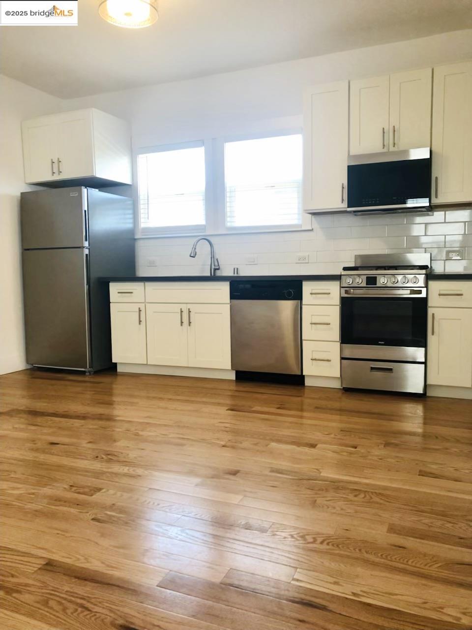 1628 Tyler Street Berkeley, CA 94703 - Photo 19 of 38 a kitchen with stainless steel appliances granite countertop a refrigerator a stove a sink and a microwave