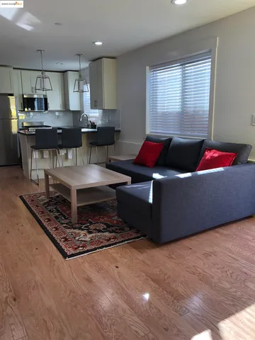 a living room with kitchen furniture and a table