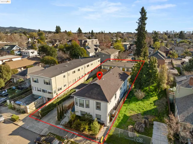 an aerial view of residential building with green space