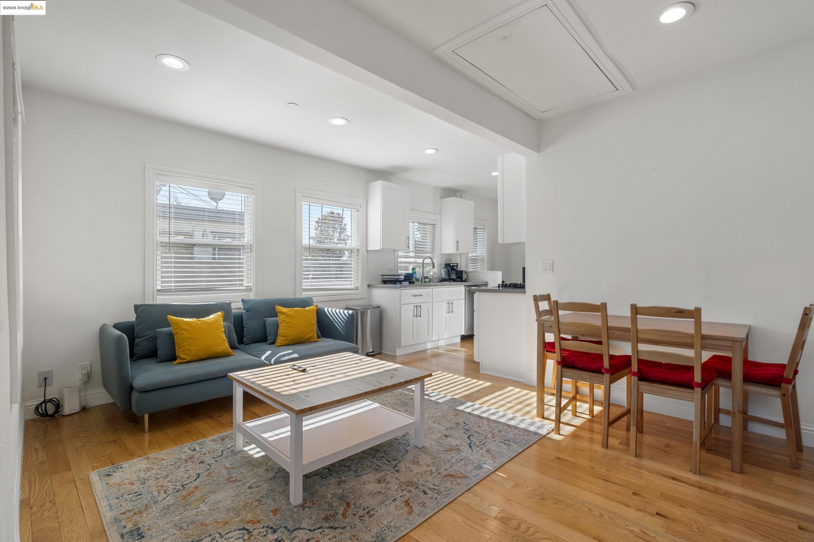 1628 Tyler Street Berkeley, CA 94703 - Photo 10 of 38 a living room with furniture and a dining table with wooden floor