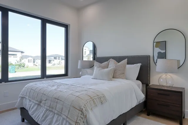 a bedroom with a bed and a window