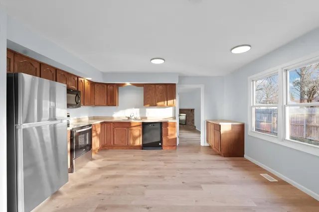 a kitchen with stainless steel appliances a refrigerator and a stove top oven