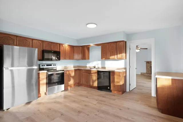 a kitchen with stainless steel appliances granite countertop a refrigerator stove and oven