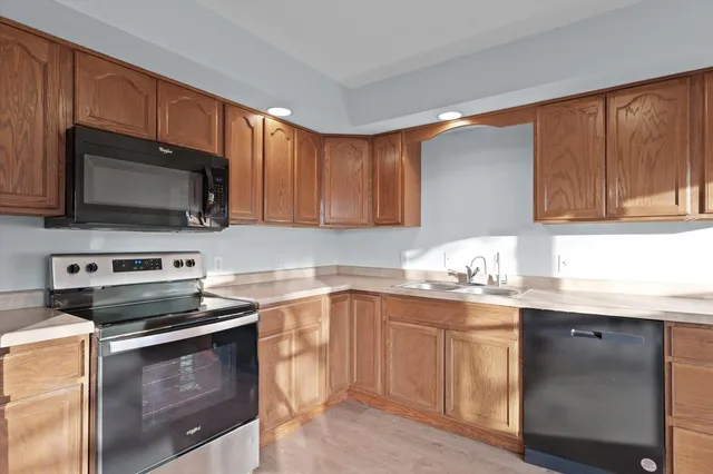 a kitchen with a sink stove and microwave