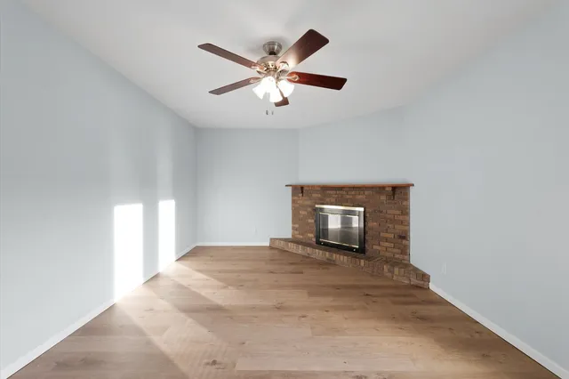 a view of a livingroom with a ceiling fan and window