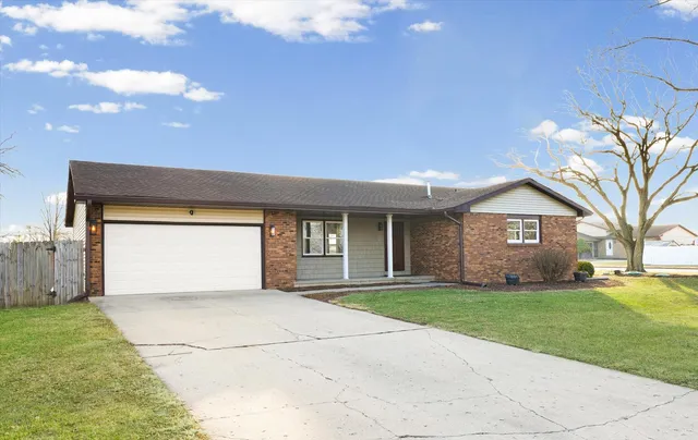 a view of a house with a yard and garage