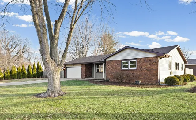 a front view of house with yard and green space