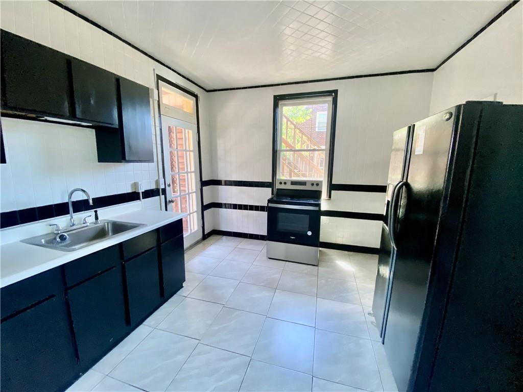 2602 Main Street Munhall, PA 15120 - Photo 7 of 21 a large kitchen with a refrigerator and a sink