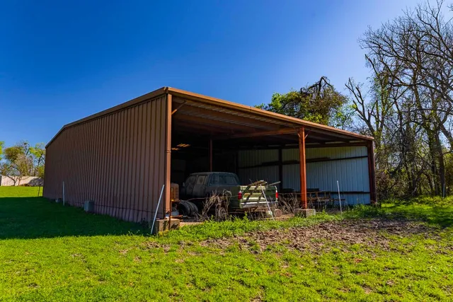 a view of backyard with cabin