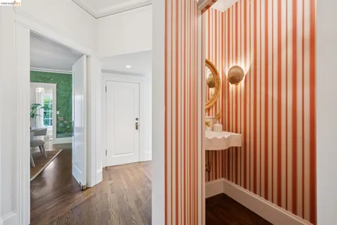 a bathroom with a double vanity sink a toilet a mirror and shower