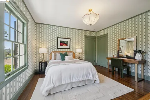 a spacious bedroom with a bed and a table with chair