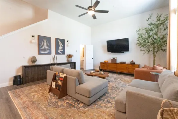 a living room with furniture and a flat screen tv