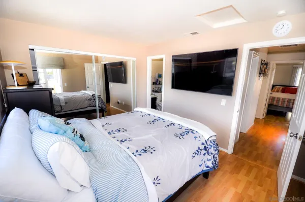 a bedroom with a bed and a flat screen tv
