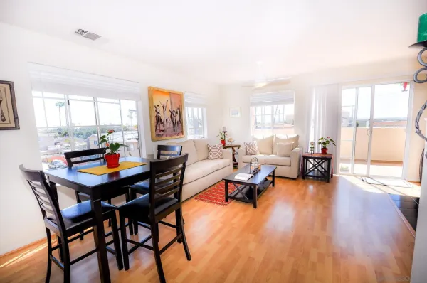 a living room with furniture and a wooden floor