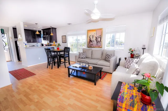 a living room with furniture and wooden floor
