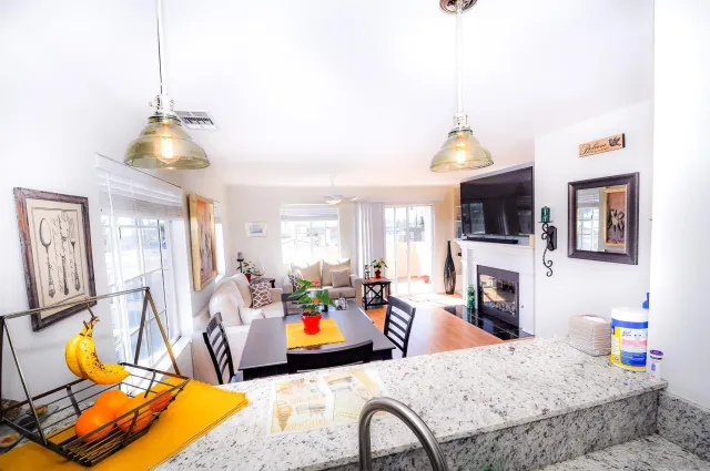 a living room with patio furniture and a flat screen tv