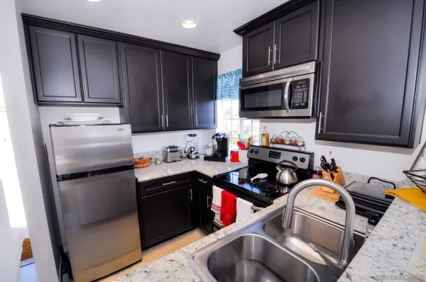 a kitchen with a sink stove and refrigerator