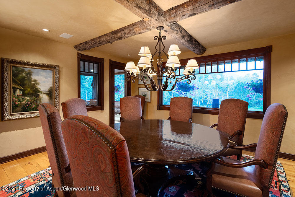 31 Northstar Circle Aspen, CO 81611 - Photo 19 of 51 a view of a dining room with furniture a chandelier and large windows