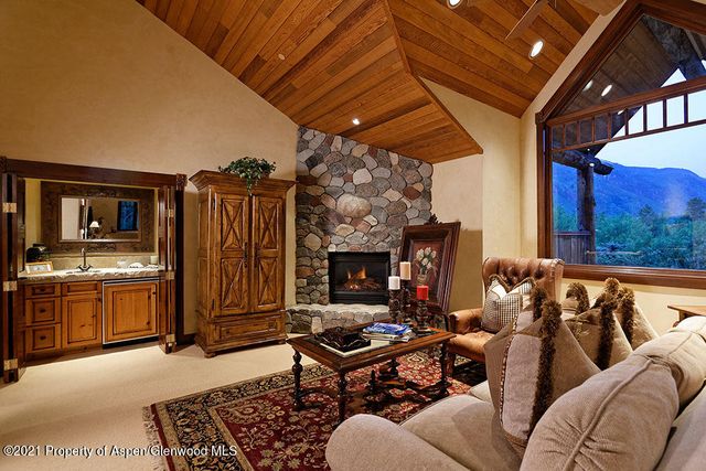 a living room with furniture a fireplace and blue walls