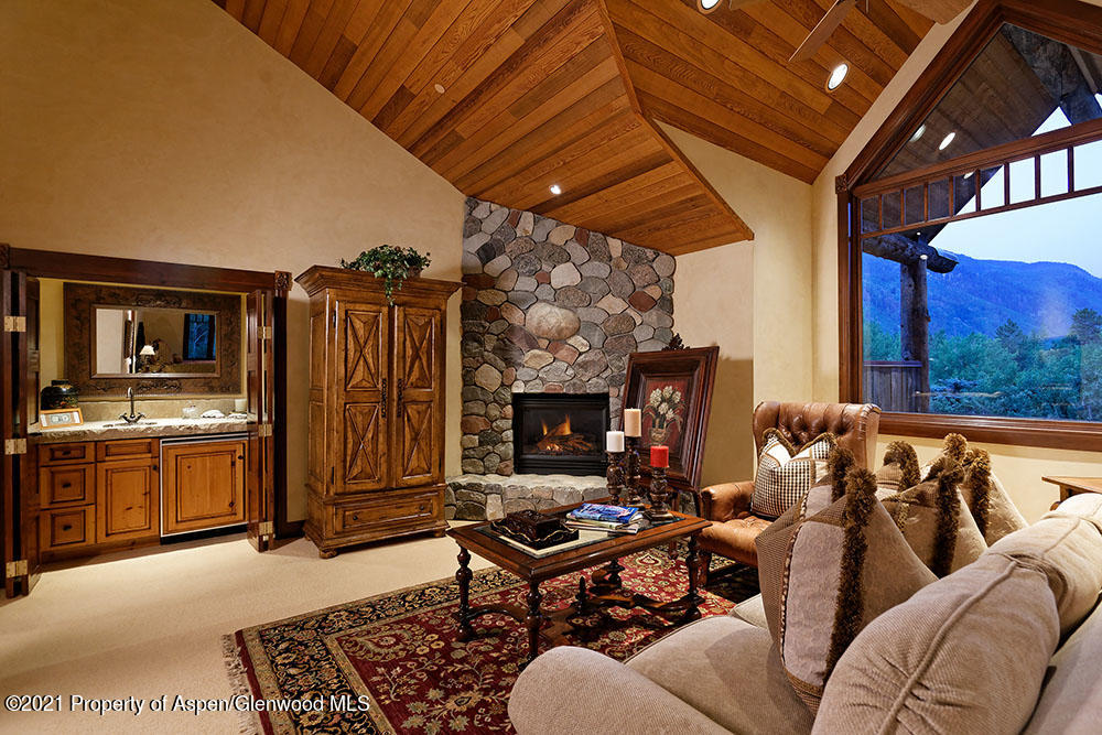 31 Northstar Circle Aspen, CO 81611 - Photo 26 of 51 a living room with furniture a fireplace and blue walls