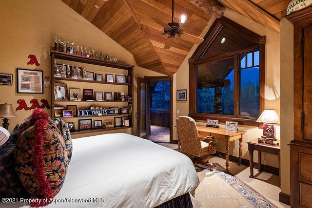 a bed room with a bed and a book shelf